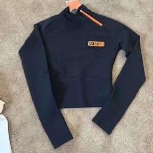 NWT P. E Nation long sleeve top with open back, size S, black with orange detail